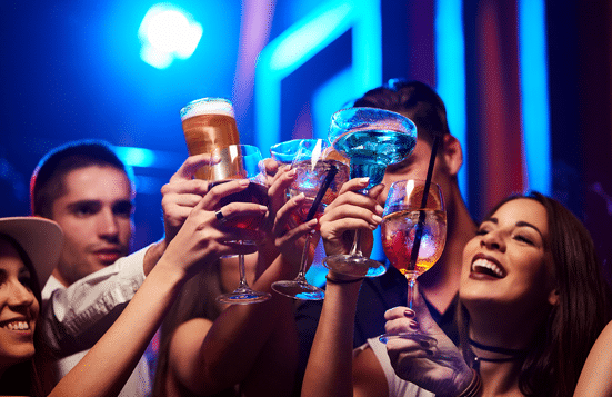 Group of people toasting glasses at Night club