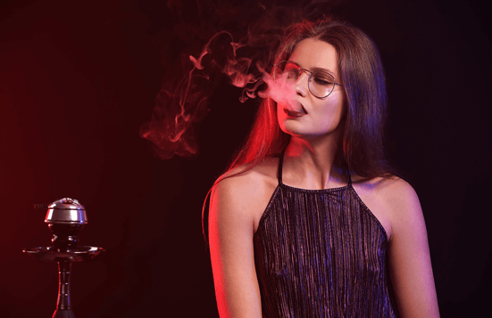 Girl smoking sheesha in a night club